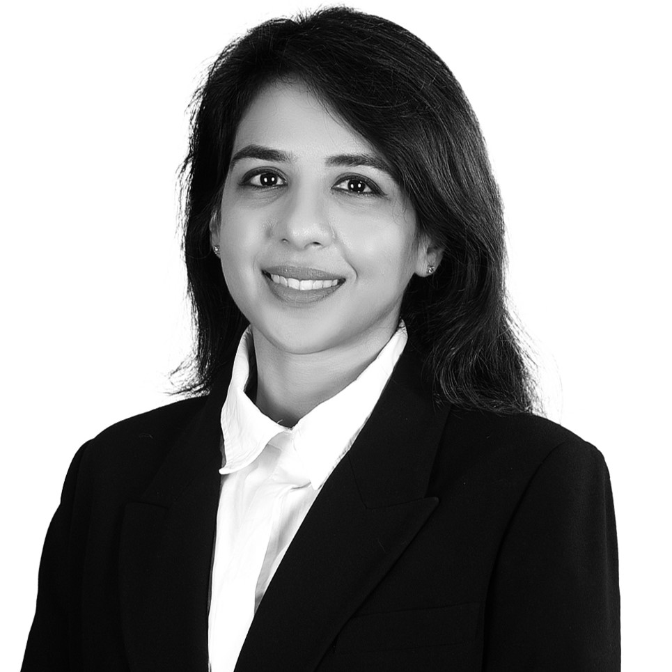 Aamna Pirzada, a lady in a black suit and white shirt