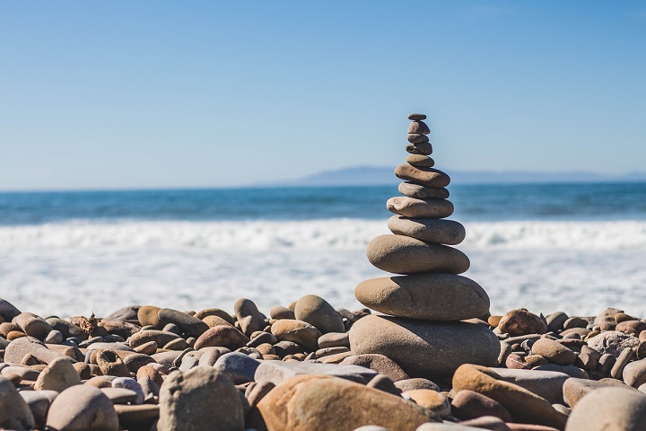 image of a stone cairn representing businesses balancing act
