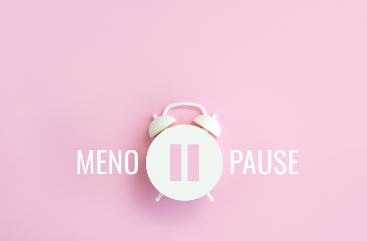 Word Menopause, pause sign on a white alarm clock on pink background. Signifying menopause at work