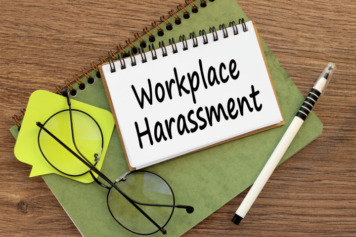image of a notepad with workplace harassment written on it for sexual harassment article