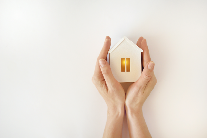 Picture of the family home in a pair of hands