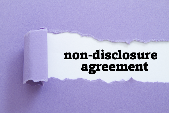 non-disclosure agreement (NDA) writte words being pealed back from an envelope